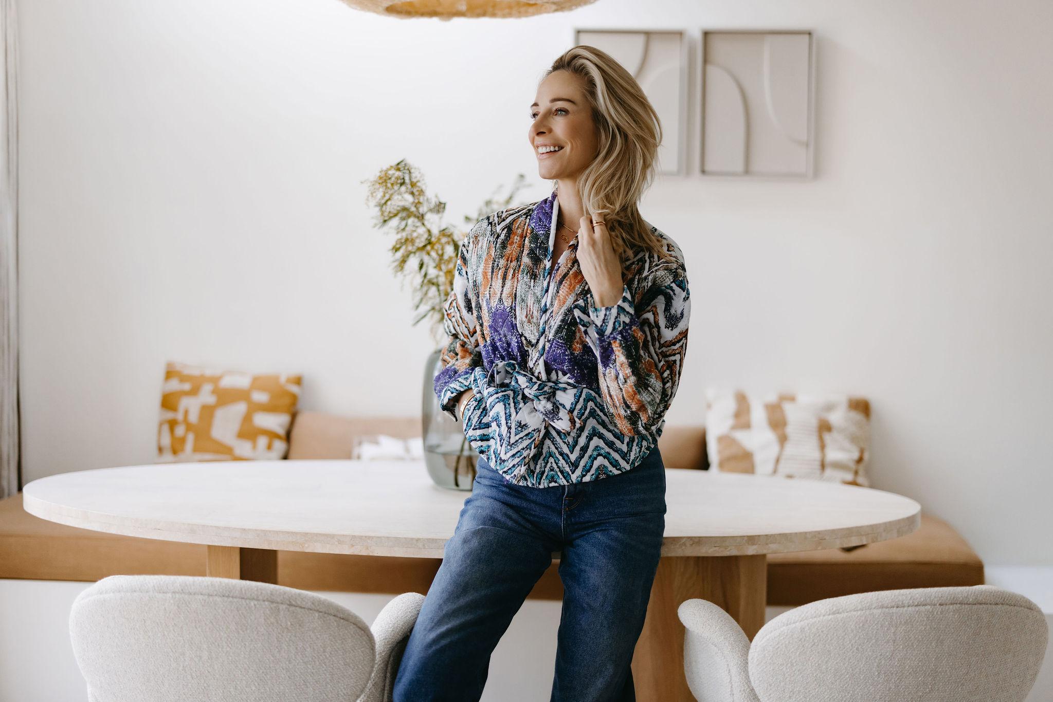 Virginie Versteegh staand bij een lichte eettafel in een rustig interieur